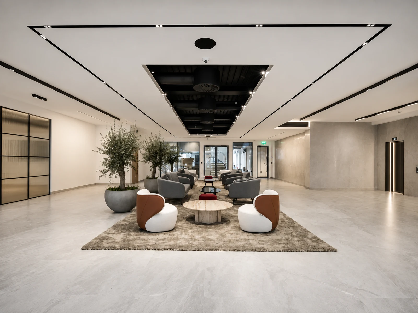 Reception lounge at the Met Building with a recessed black services ceiling and pale polished wall finishes