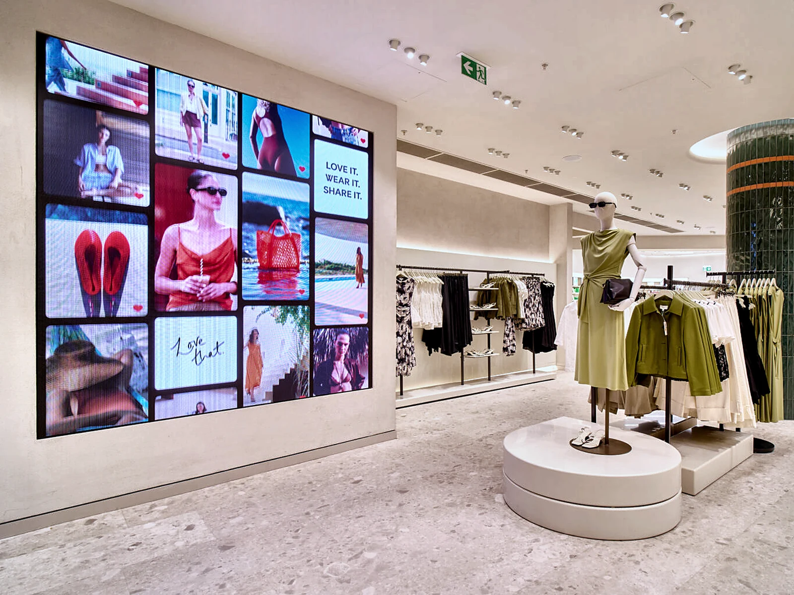 Womenswear floor at M&S Pantheon with a large LED screen wall set into a stone-toned finished wall