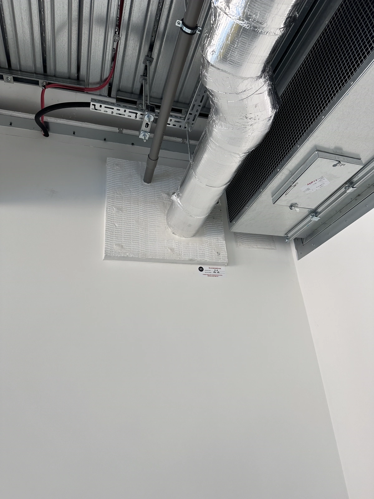 Fire-stopping seal to a service penetration, with installation record label